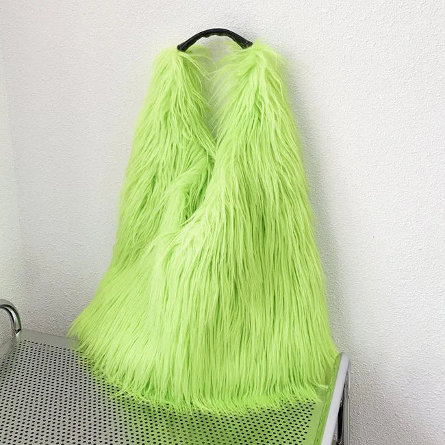 Neon green fur bag on a trolley against a white wall