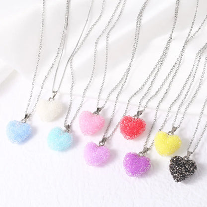 Necklaces with colourful heart-shaped pendants on a white background