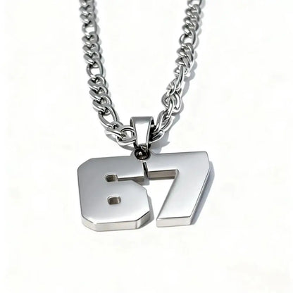 Silver necklace with number '67' pendant on a white background