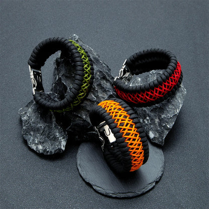 Four braided paracord bracelets in black, green, red, and orange on a grey background