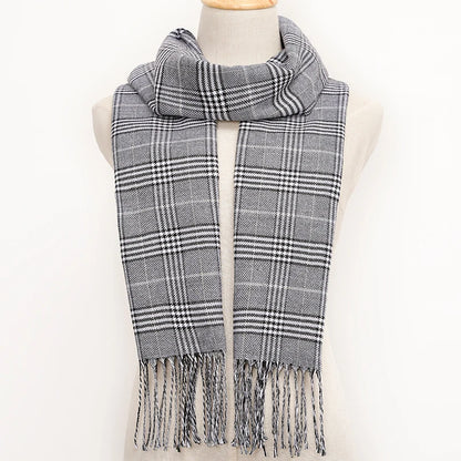 Plaid scarf with fringes on a mannequin against a white background