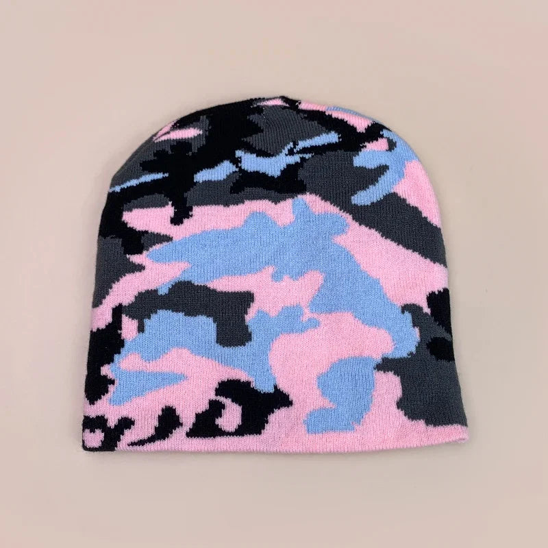 Camouflage-patterned beanie in pink, blue, and black on a beige background