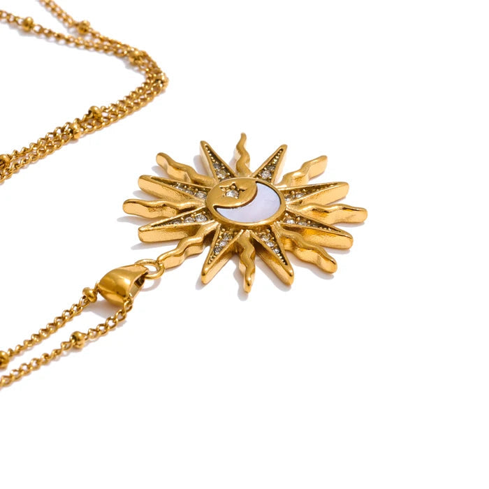 Gold necklace with sun and moon design on a white background