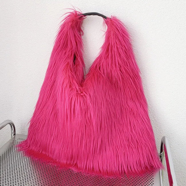 Pink shaggy bag on a metal trolley against a white wall