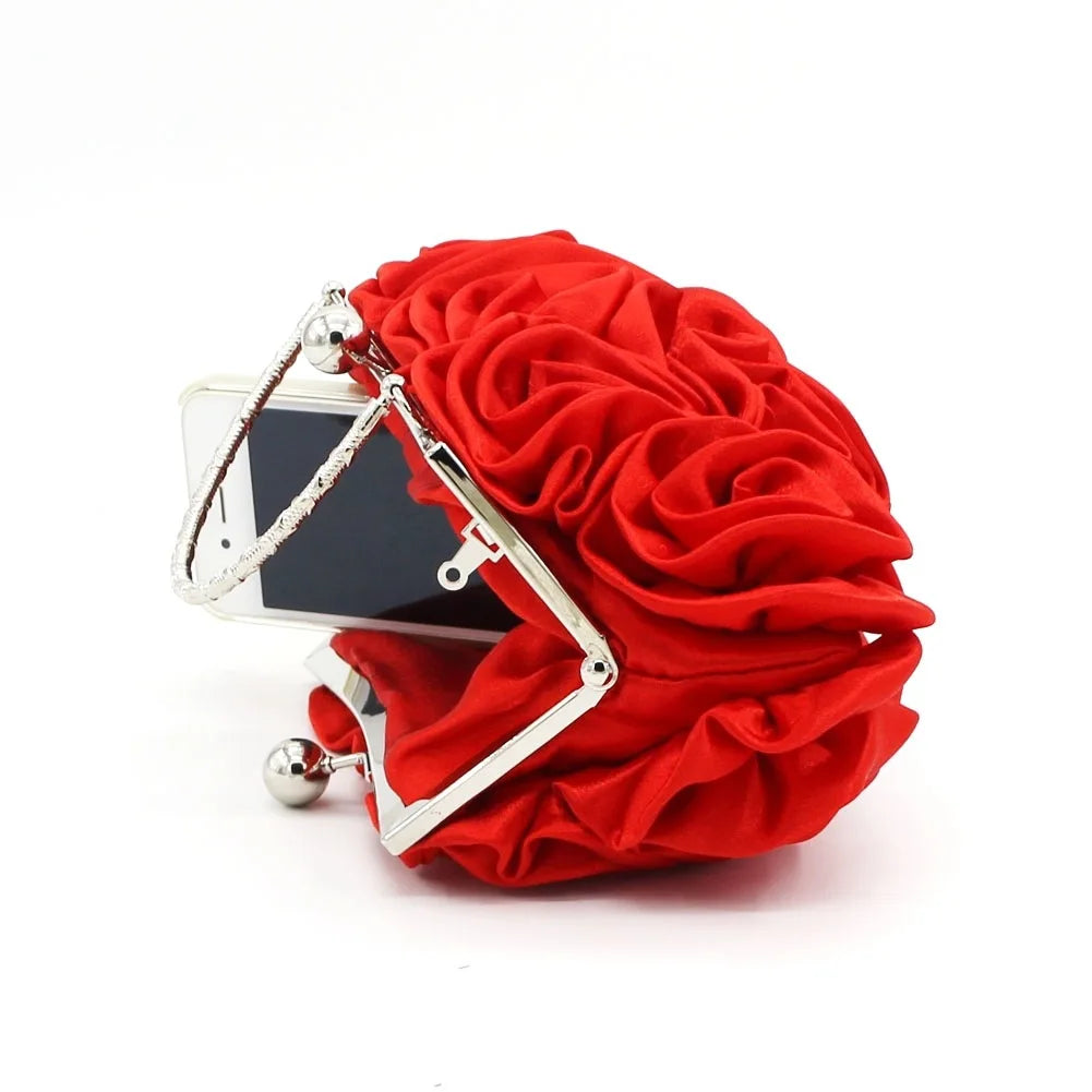 Red floral clutch bag with silver frame on a white background