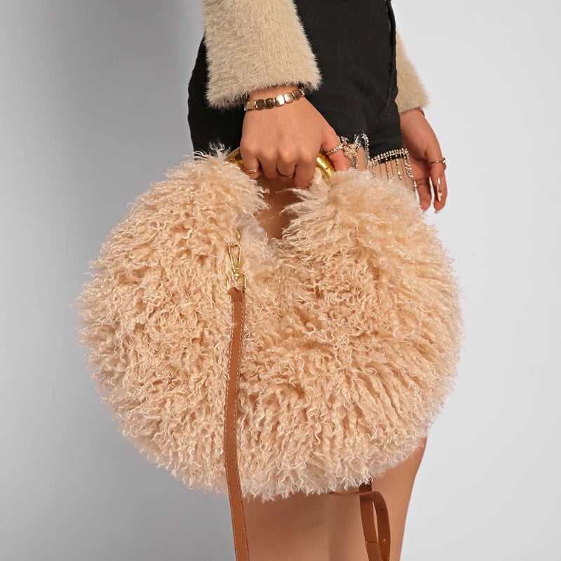 Beige fluffy handbag held by a person against a grey background