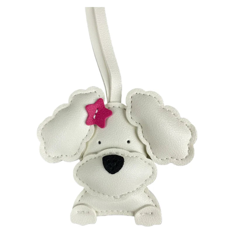 White dog-shaped keychain with a pink bow on a white background
