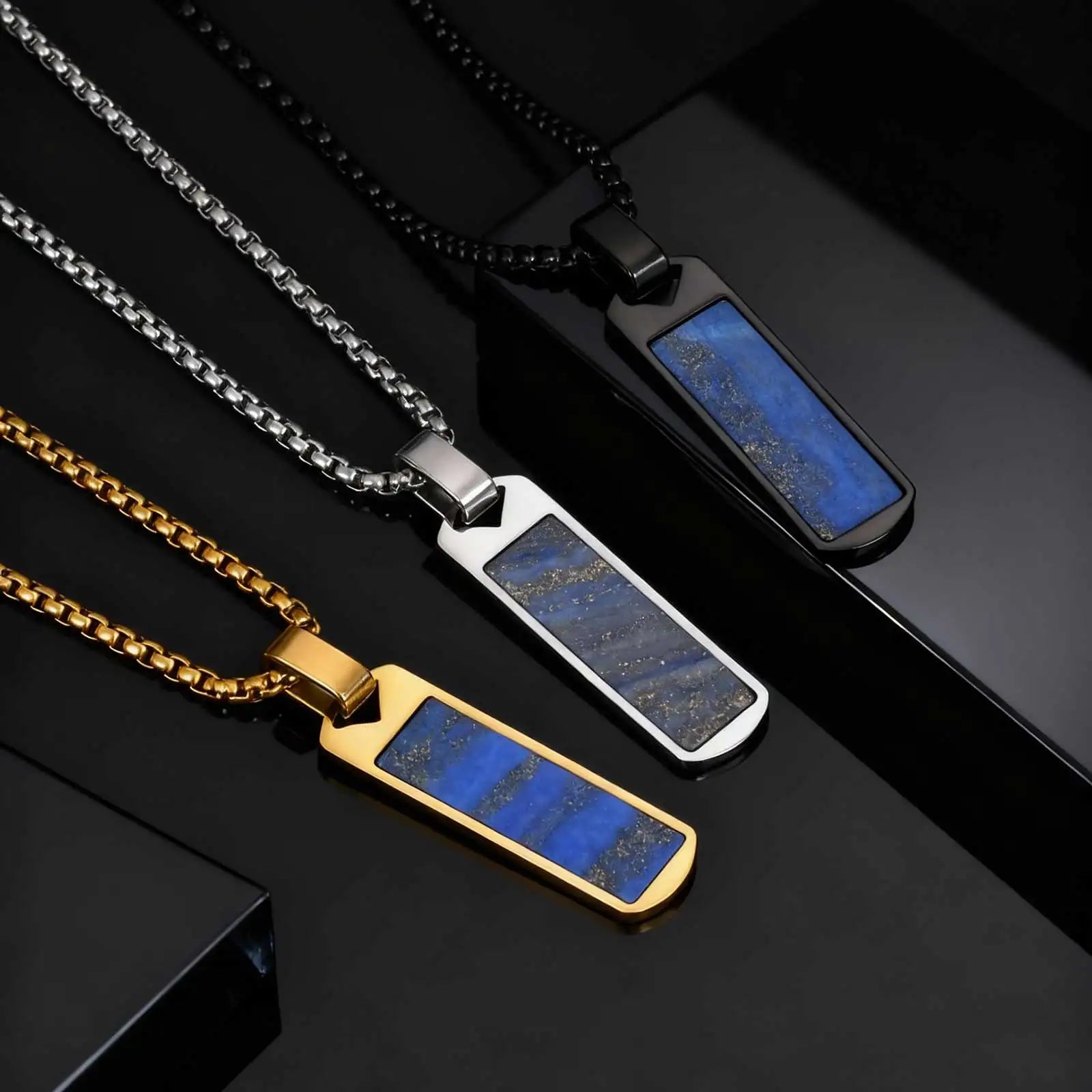 Three necklaces with blue stone pendants on a black background