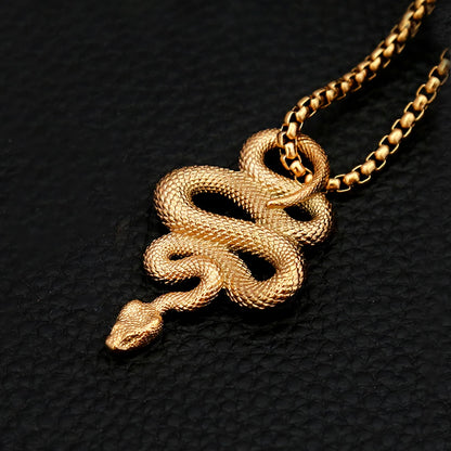 Gold snake pendant necklace on a black textured background