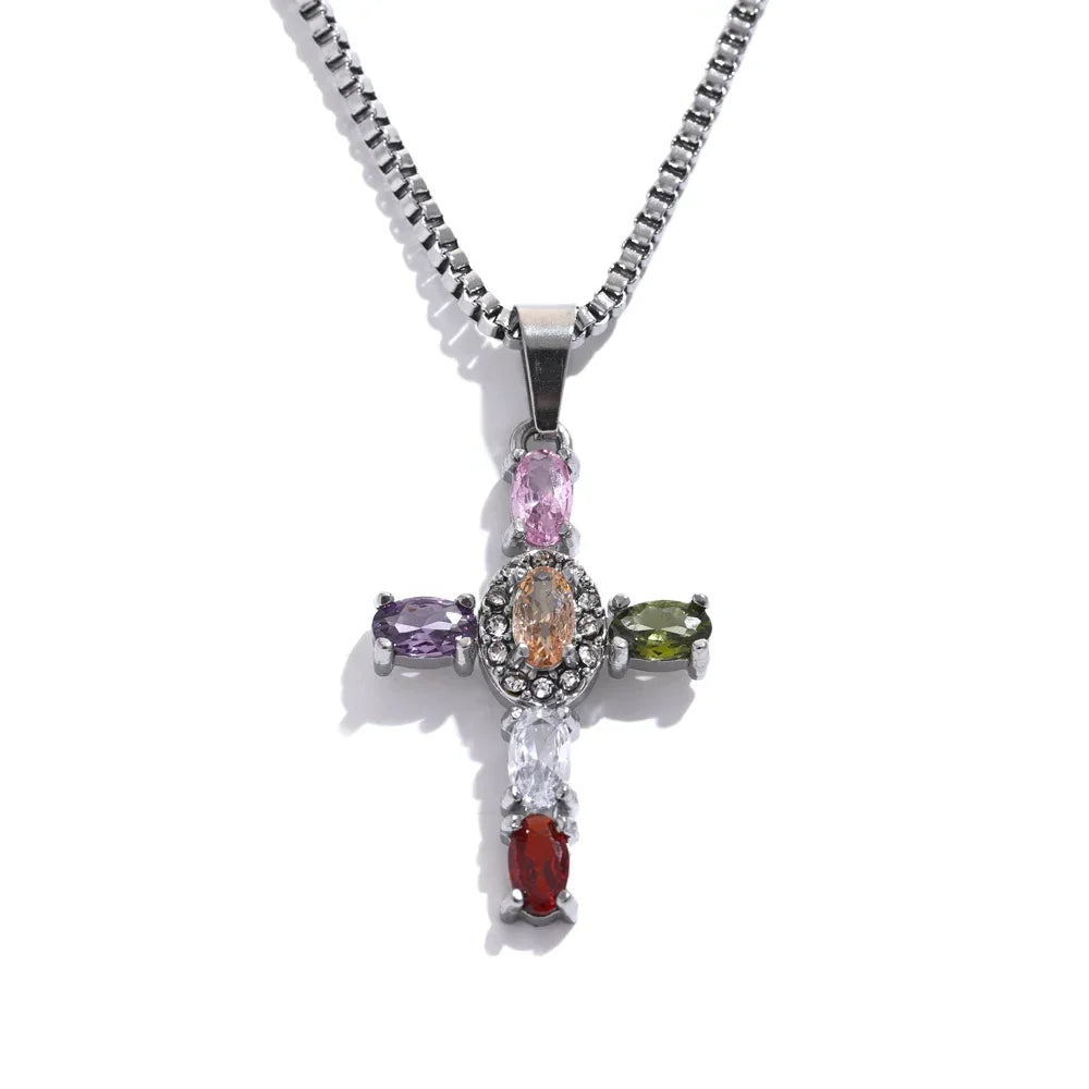 Multicoloured gemstone cross pendant on a silver chain against a white background