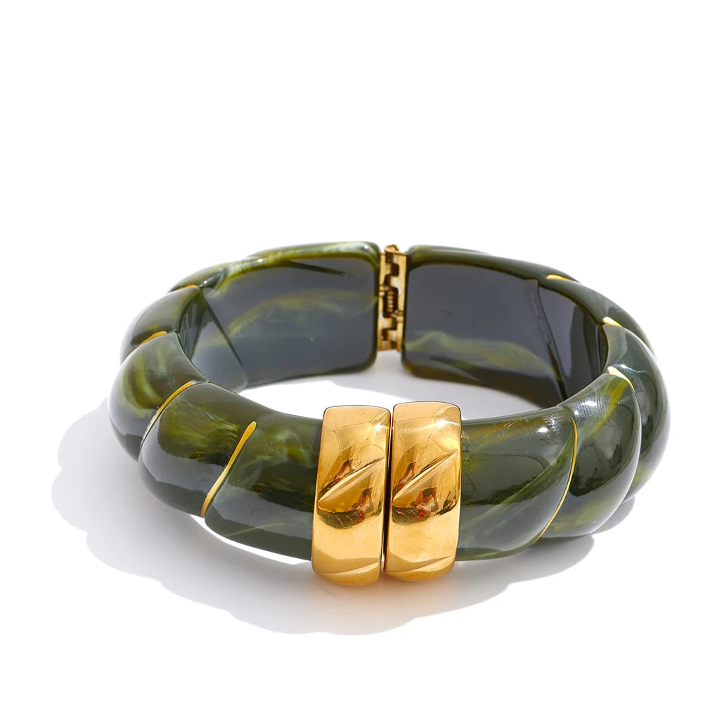 Green and gold bracelet on a white background
