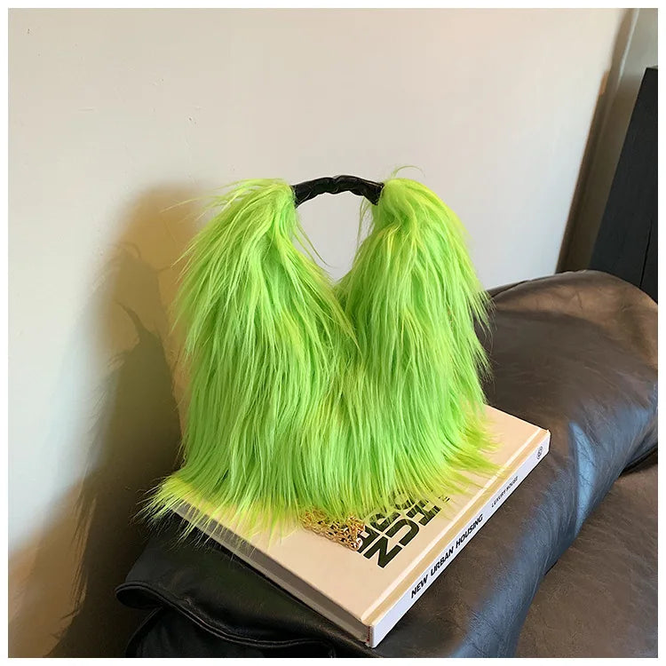 Neon green furry bag on a book with a blurred background