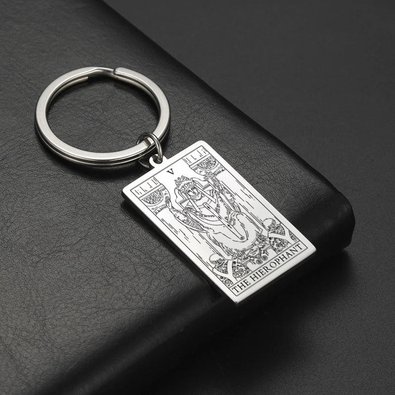 Keychain with tarot card design on a dark surface