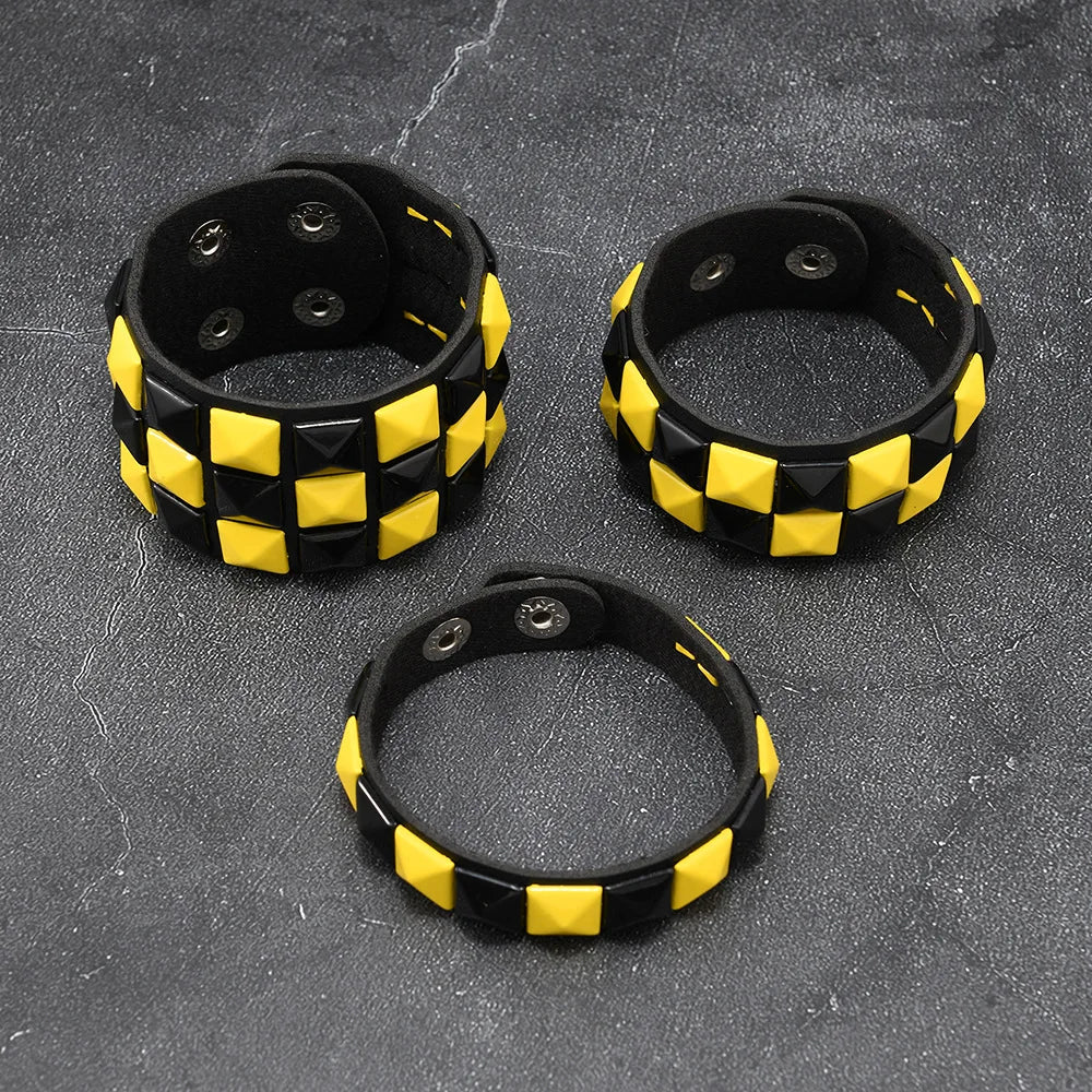 Three black and yellow checkered bracelets on a textured grey surface