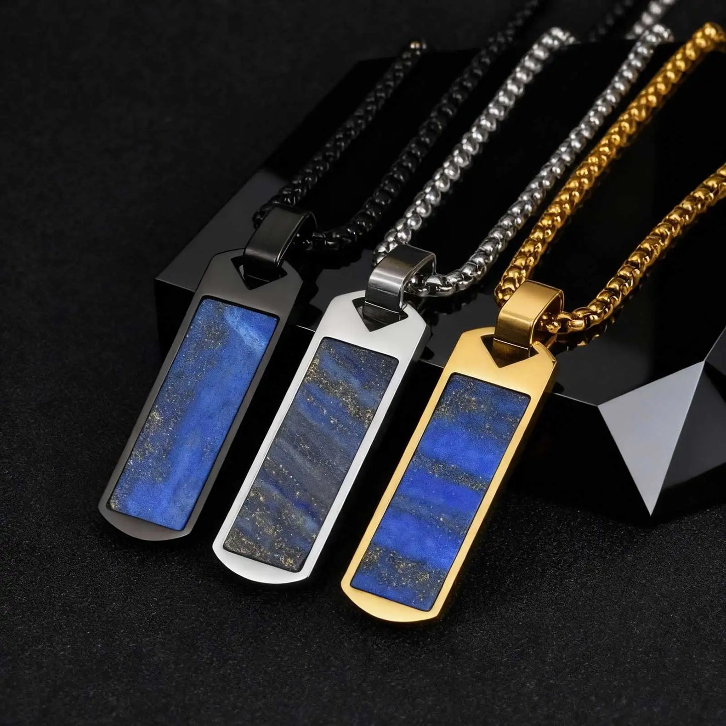 Three necklaces with blue lapis lazuli stone pendants on black background