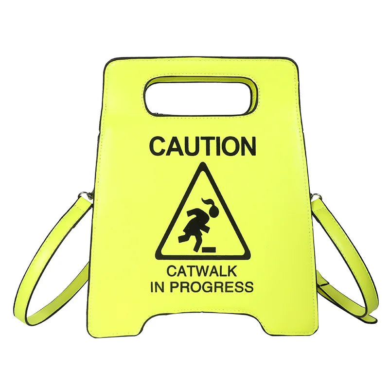 Yellow caution sign with 'Catwalk in Progress' text and symbol on a white background