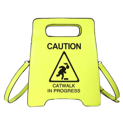 Yellow caution sign with 'Catwalk in Progress' text and symbol on a white background