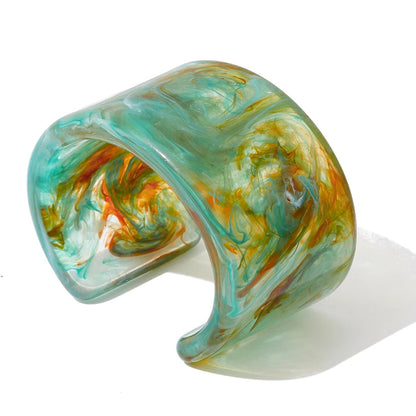 Marbled green and orange bracelet on a white background