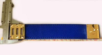 Blue leather strap bracelet with gold hardware on a white background, measured by a ruler.