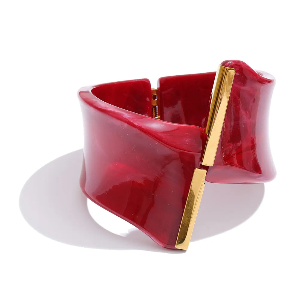 Red bracelet with a gold clasp on a white background