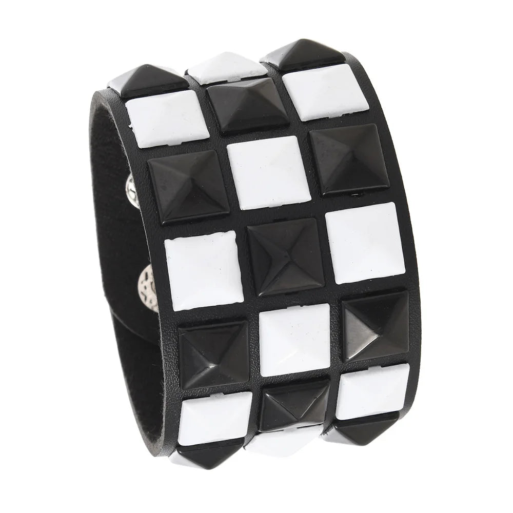 Black and white checkered bracelet with pyramid studs on a white background