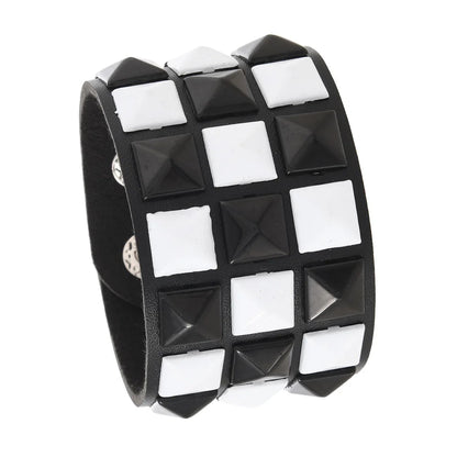 Black and white checkered bracelet with pyramid studs on a white background