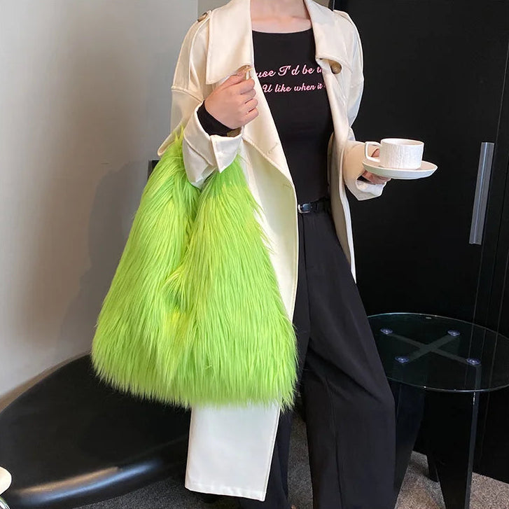 Person holding a bright green fluffy bag and a white cup with a black interior.