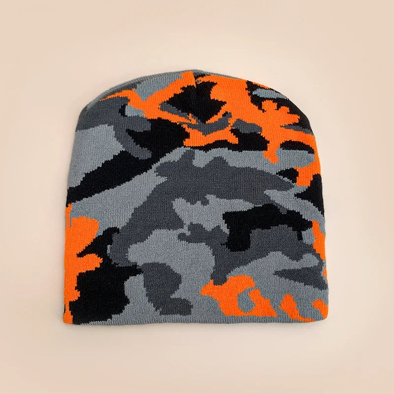Camouflage-patterned beanie with orange, black, and grey colours on a beige background