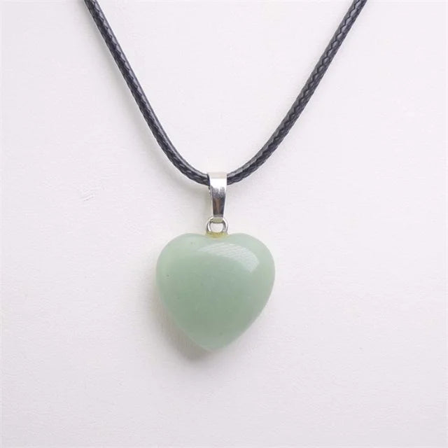 Heart-shaped green pendant on a black cord against a white background