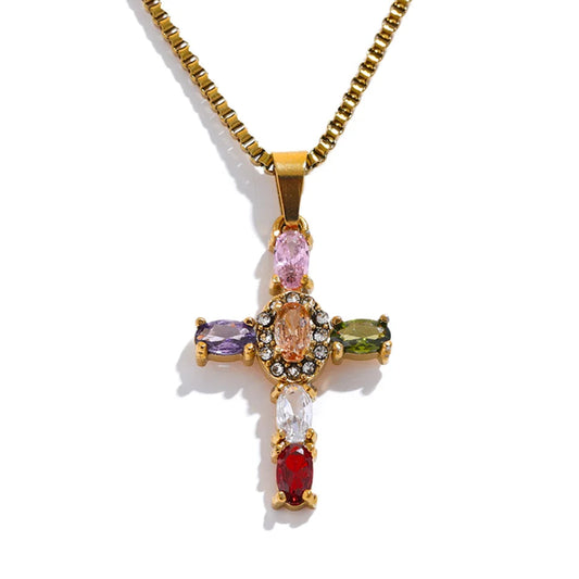 Gold cross pendant with colourful gemstones on a white background