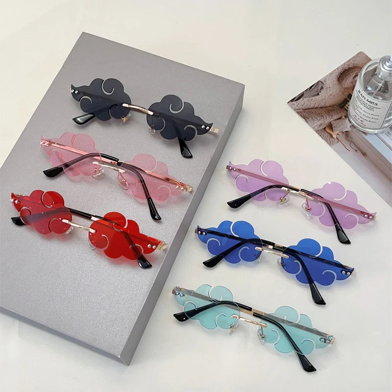 Colourful sunglasses with cloud-shaped lenses on a grey surface.