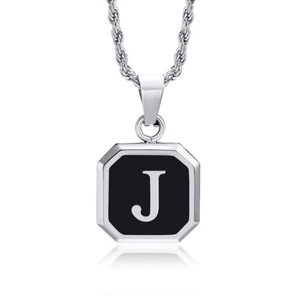 Necklace with a black octagonal pendant featuring the letter 'J' on a white background