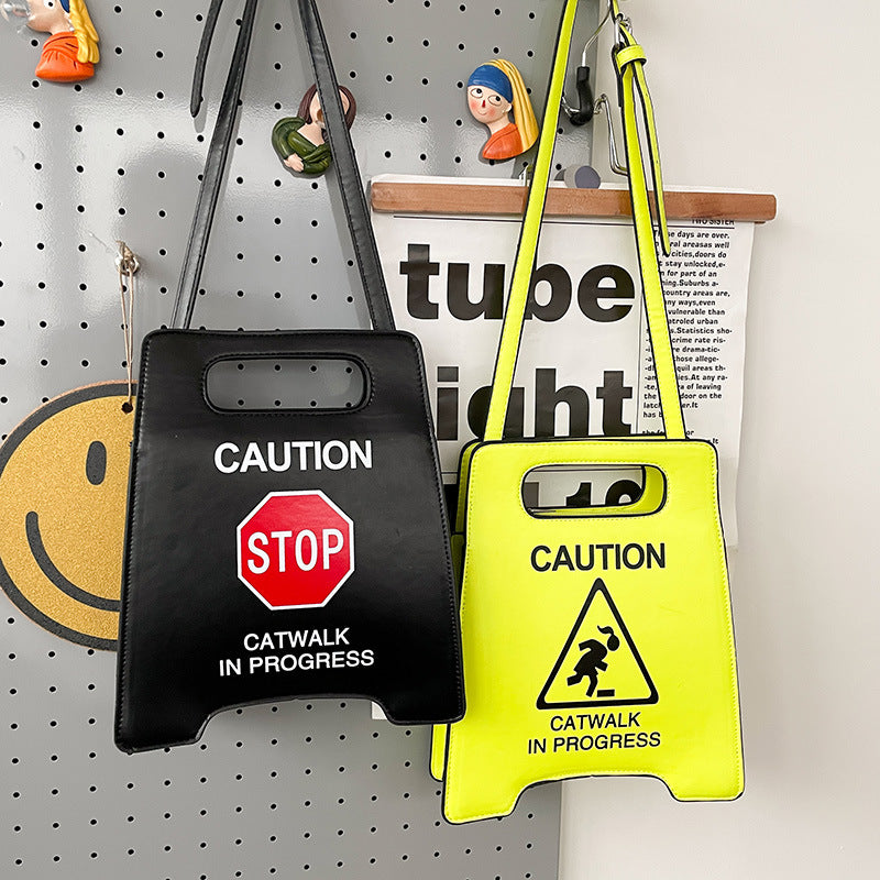 Two bags with caution signs on a pegboard background