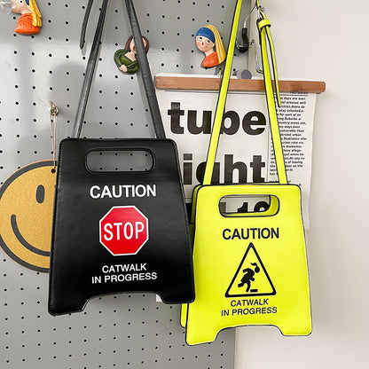 Two bags with caution signs on a pegboard background