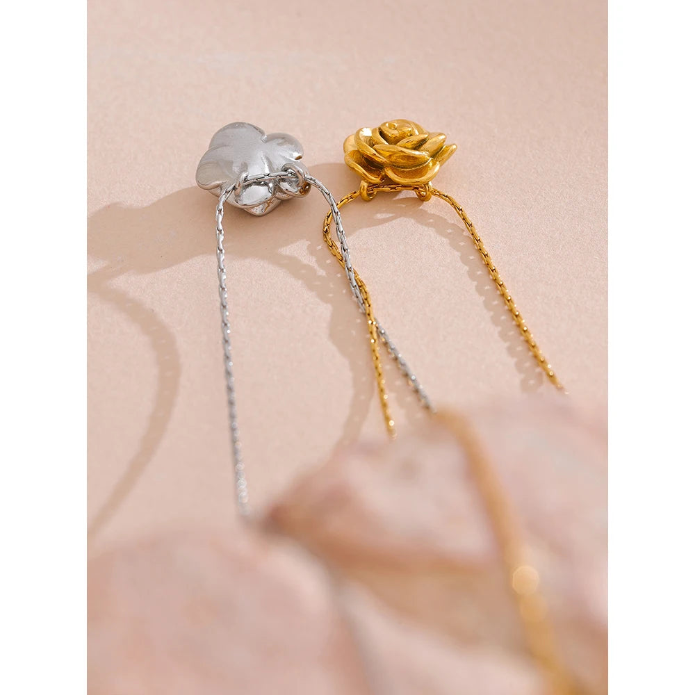 Gold and silver necklaces on a soft pink background