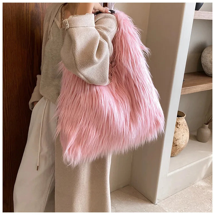 Person holding a pink fluffy bag in a neutral indoor setting