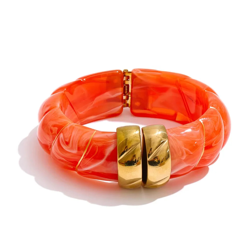 Orange bracelet with gold clasp on a white background