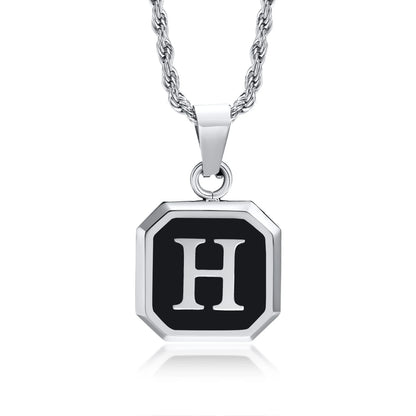 Silver necklace with a black octagonal pendant featuring the letter 'H' on a white background