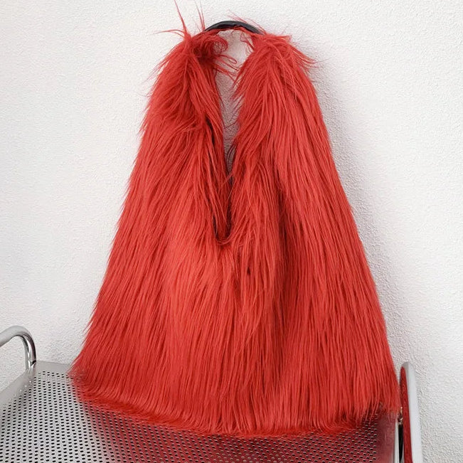 Red fluffy bag on a metal trolley against a white wall