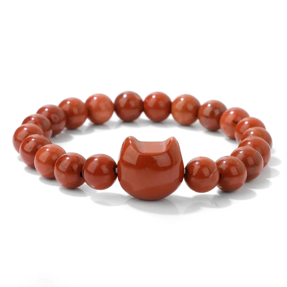 Bracelet with red beaded design on a white background