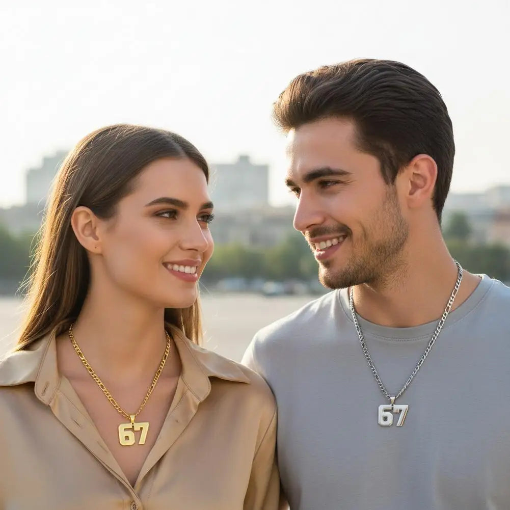 Man and woman wearing necklaces with numbers 67, standing outdoors.