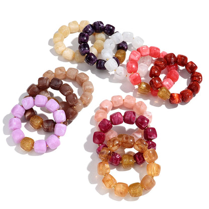Set of colourful beaded bracelets on a white background