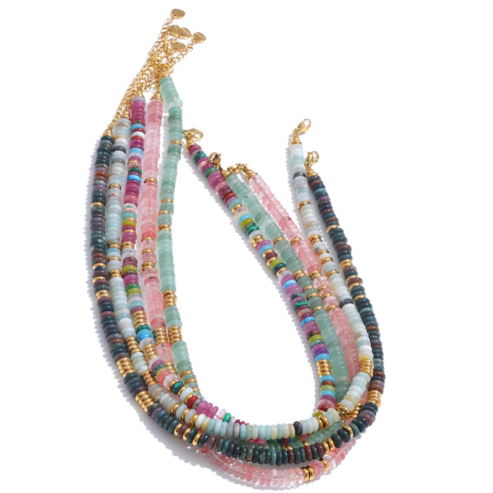 Multicoloured beaded necklace with gold accents on a white background