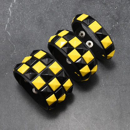 Black and yellow checkered bracelets on a grey background
