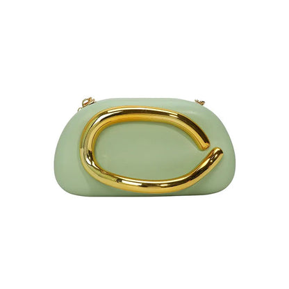 Light green clutch with gold handle on a white background