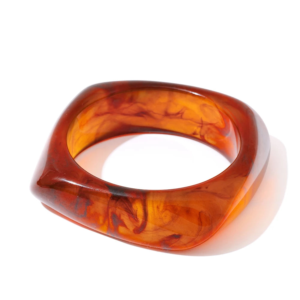 Orange-brown bangle on a white background