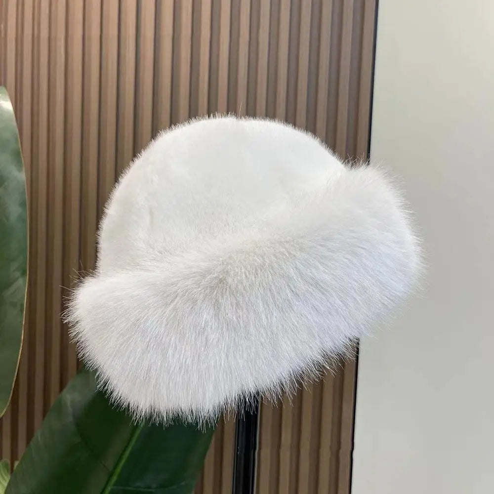White fluffy hat against a neutral background