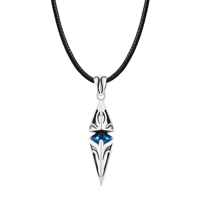 Silver pendant with blue gemstone on a black cord against a white background