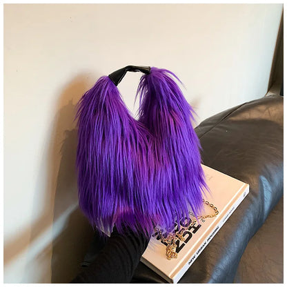 Purple fluffy fur handbag on a book with a neutral background