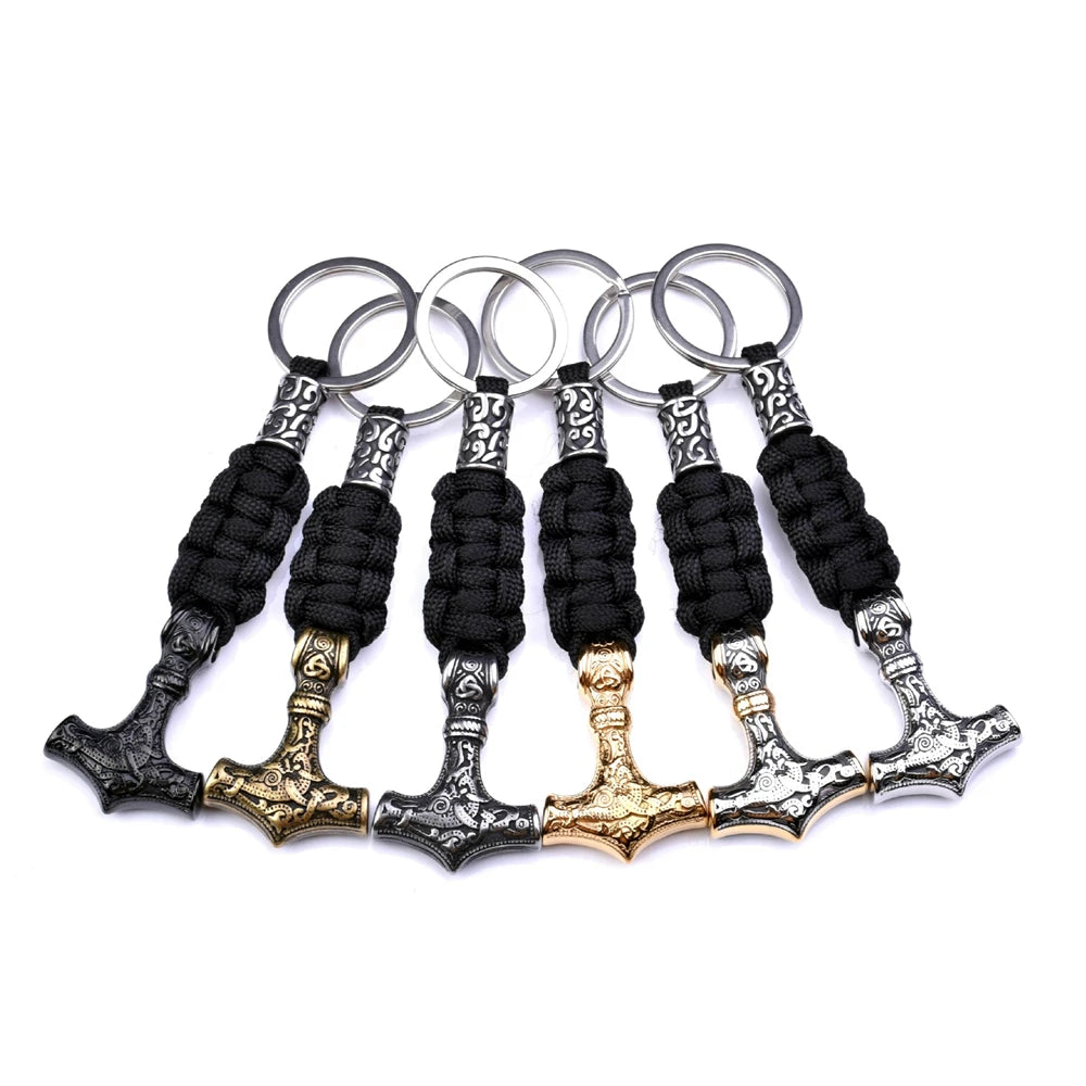 Set of Thor's hammer keychains with black paracord handles on a white background